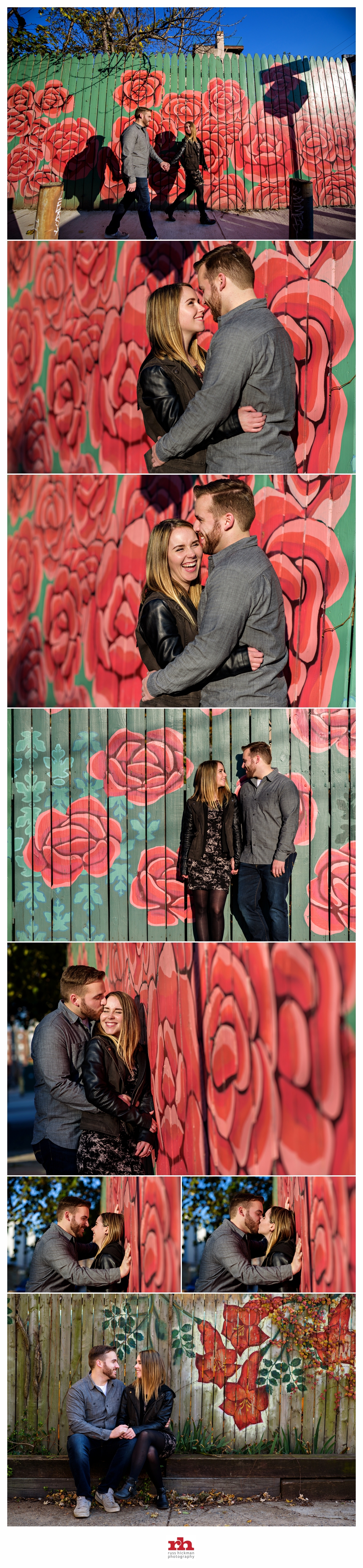 A Couple in front of a Rose wall embrace during their Philadelphia Engagement Session.